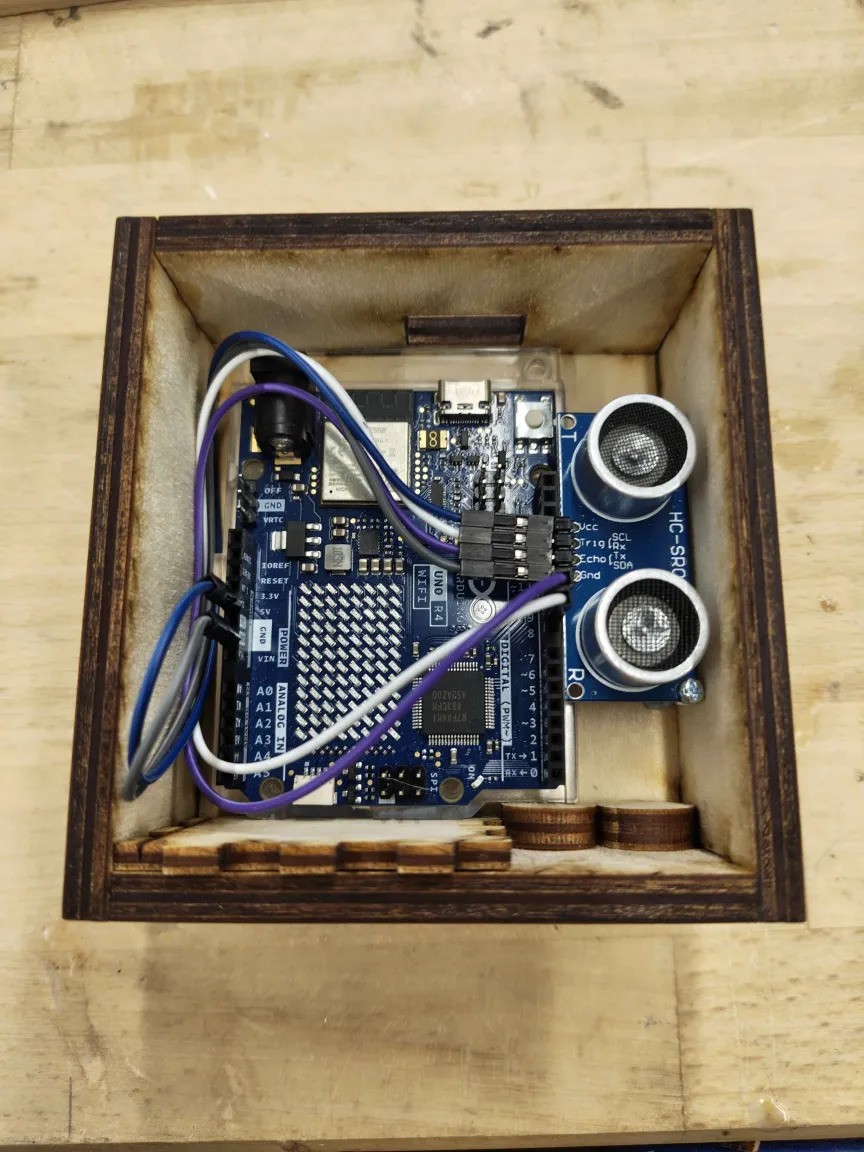 Image of wooden box with components inside.